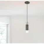 Close-up of the HMS hanging light showing the bronze mesh pattern and clear glass shade, brass hardware, E26 socket