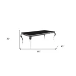 Black and white glass dining table with stainless steel base in modern home