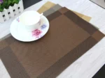 Gold weave placemats on a dining table with plates and cutlery