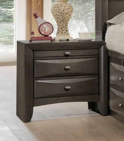 Solid wood nightstand with two drawers and knob pulls beside a bed in a modern bedroom