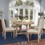 Farmhouse dining table set with extendable round solid wood table and four upholstered chairs in natural wood wash finish