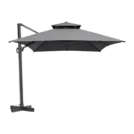 Dark gray rectangular tilt cantilever patio umbrella with stand in outdoor setting