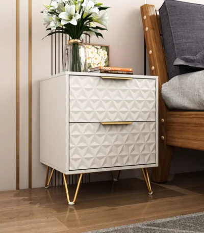 Modern nightstand with gold legs and 3D embossed drawer front in ancient white finish
