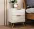 Modern nightstand with drawers, gold legs, and 3D embossed design in a bedroom setting
