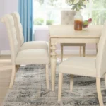 Urban style wired white dining table with turned legs and wood grain finish in a modern home setting