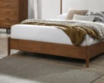 Adjustable full size bed with walnut panel headboard and beige upholstery featuring diamond crystal design and oak slat support