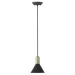 Small square acrylic and iron pendant light illuminated with warm white light, casting a cozy glow in a hotel lobby