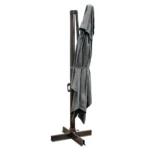 Dark gray rectangular tilt cantilever patio umbrella with stand in outdoor setting