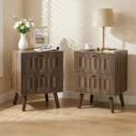 Modern double drawer nightstand with solid wood legs in walnut finish against a bedroom wall