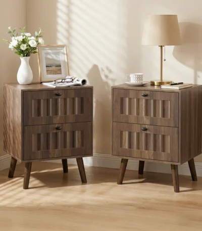 Modern double drawer nightstand with solid wood legs in walnut finish against a bedroom wall