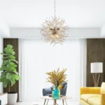 The chandelier installed above a dining table, casting intricate shadows and complementing a boho decor style.