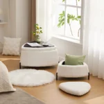 White faux fur storage ottoman set of 2 with metal legs placed in bedroom as footrest and shoe changing stool