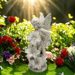 Solar fairy statue glowing in a garden at dusk