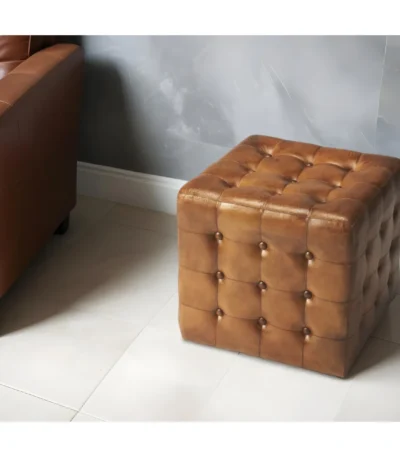Goldoma brown tufted faux leather cube ottoman as footrest and extra seat in living room