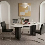Modern glass dining table set with marble pattern and gold metal legs in a dining room setting
