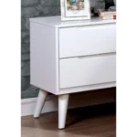 Modern white nightstand with 2 drawers and tapered legs in a bedroom setting
