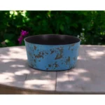 Large blue planter with powder-coated finish on a patio