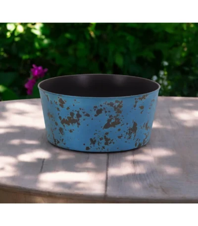Large blue planter with powder-coated finish on a patio