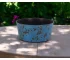 Large blue planter with powder-coated finish on a patio