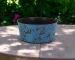 Large blue planter with powder-coated finish on a patio