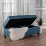 Purple fabric storage ottoman with hidden compartment and birch wood legs in a living room