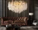 Gold crystal chandelier hanging in modern dining room with golden light reflections