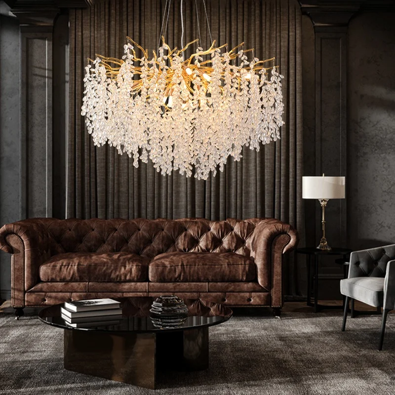 Gold crystal chandelier hanging in modern dining room with golden light reflections