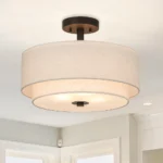 The semi flush light illuminated in a modern living room, casting soft shadows on the wall.