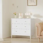 Modern white 3 drawer dresser with gold-tone knobs and lacquer finish in a bedroom setting