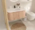 Goldoma wall-mounted bathroom vanity with round basin, white finish, installed in a modern bathroom setting, front view.