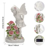 White resin garden statue with a flower fairy design placed among blooming plants.