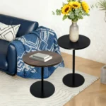Set of two small round side tables with concentric circle walnut wood tops and black metal pedestal bases, modern design for living room or bedroom