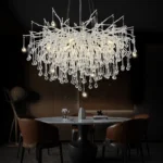 Modern crystal chandelier in black chrome and gold with raindrop crystals hanging in a living room