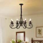 Chandelier hanging in a bedroom with high ceiling, complementing vintage iron bed frame and neutral tones.