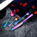 Elegant gold flatware set with fork, knife, and spoon on a white tablecloth