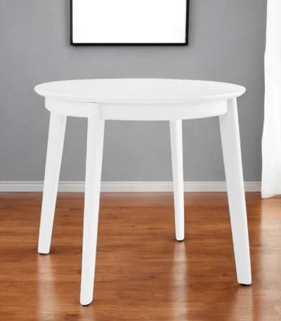 Goldoma 36-inch round dining table with white wood top and sintered stone finish, showcasing industrial design in a home dining setting