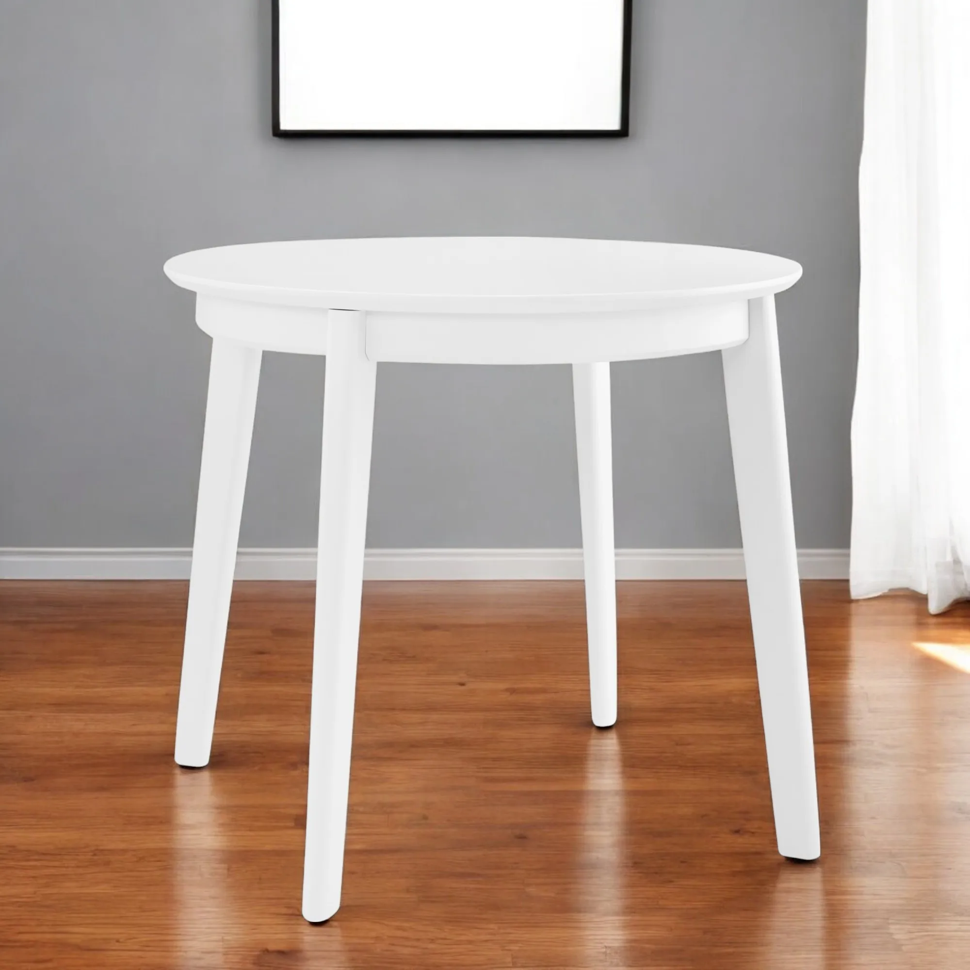 Hc32a3800120e44f888a1447187993b04y.webp Goldoma 36-inch round dining table with white wood top and sintered stone finish, showcasing industrial design in a home dining setting
