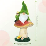 Gnome mushroom statue with solar lights illuminating the garden bed, surrounded by green ferns.