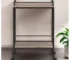Gray and black steel rolling bar cart with wine bottles and glasses on display