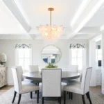 Vintage gold chandelier hanging over a dining table with warm glow