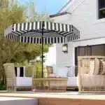 Black patio umbrella with tilt mechanism in outdoor setting