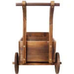 Empty wooden wagon planter with handle and wheels, displayed on a deck.