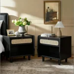 Black nightstand with rattan drawer detail and open shelf in a modern bedroom