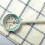 Japanese ceramic dinnerware set with hand-drawn cat design on blue rectangular plate and bowl