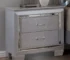 Silver LED nightstand with dovetail drawers and soft LED lighting in a modern bedroom