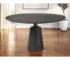 Brown solid wood dining table with metal pedestal base in a modern dining room