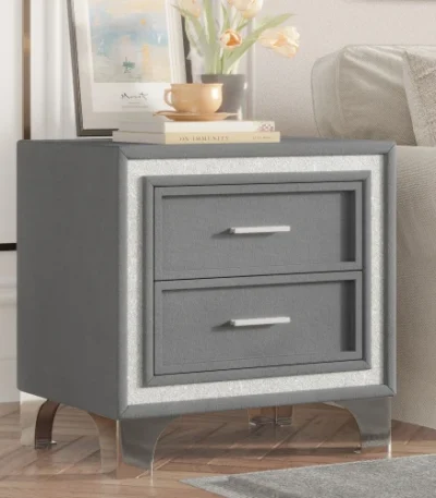 Modern velvet nightstand with silver glitter strip decor and two drawers, placed beside a bed in a bedroom