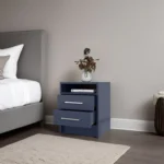Kronos Blue nightstand with two drawers and open shelf in a modern bedroom setting.