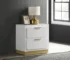 Sophia white nightstand with drawers and gold accents in a bedroom setting
