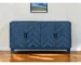 Distressed blue sideboard with chevron wood texture and four doors in a living room
